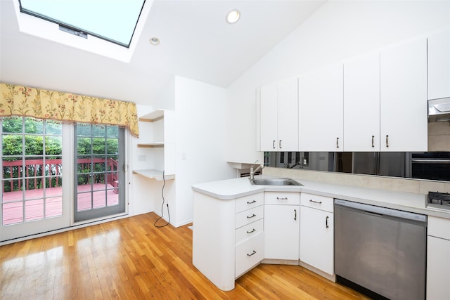 18 Sutton Ter, Jericho, NY 11753 - kitchen featuring appliances with stainless steel finishes, lofted ceiling, light countertops, white cabinetry, and light wood-style floors