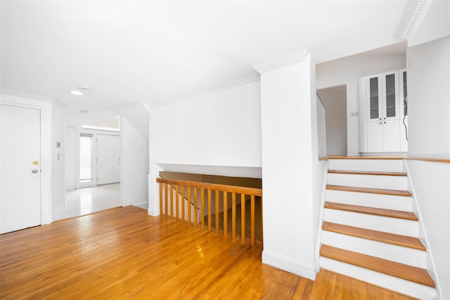 18 Sutton Ter, Jericho, NY 11753 - empty room with stairs, wood-type flooring, and ornamental molding