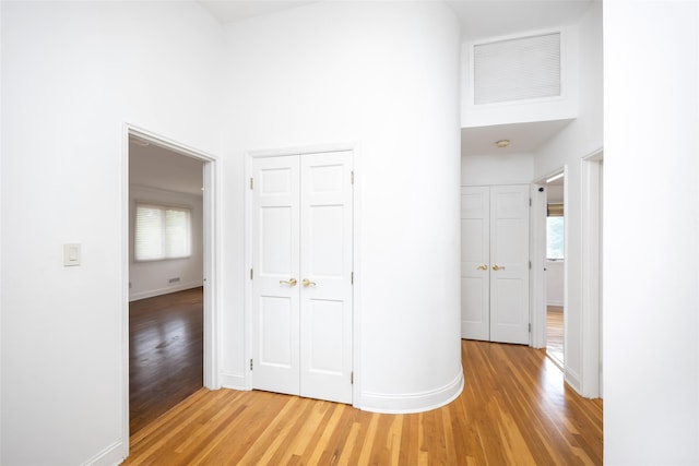 18 Sutton Ter, Jericho, NY 11753 - hallway with light wood finished floors, healthy amount of natural light, and a towering ceiling