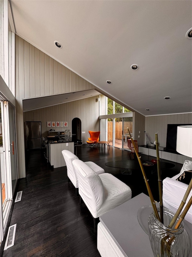 487 Tarpon Walk, Fire Island Pines, NY 11782 - living room with dark wood-style flooring, vaulted ceiling, and wooden walls