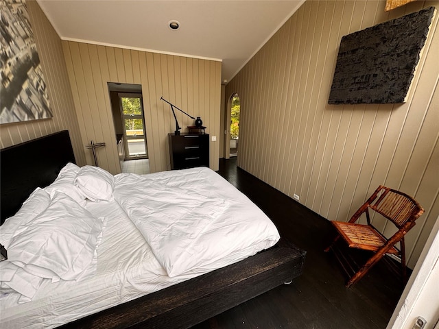 487 Tarpon Walk, Fire Island Pines, NY 11782 - bedroom featuring crown molding, dark wood-style flooring, and wood walls