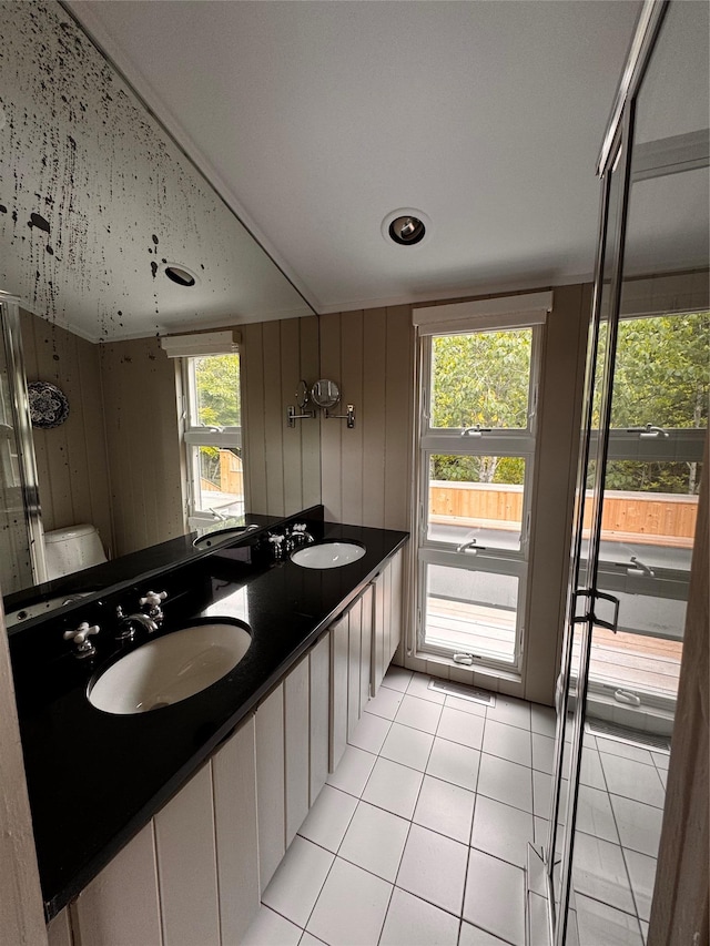 487 Tarpon Walk, Fire Island Pines, NY 11782 - full bath featuring double vanity, tile patterned flooring, healthy amount of natural light, and wood walls