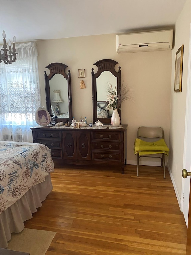 2896 Coddington Ave, Bronx, NY 10461 - bedroom with an AC wall unit and wood finished floors