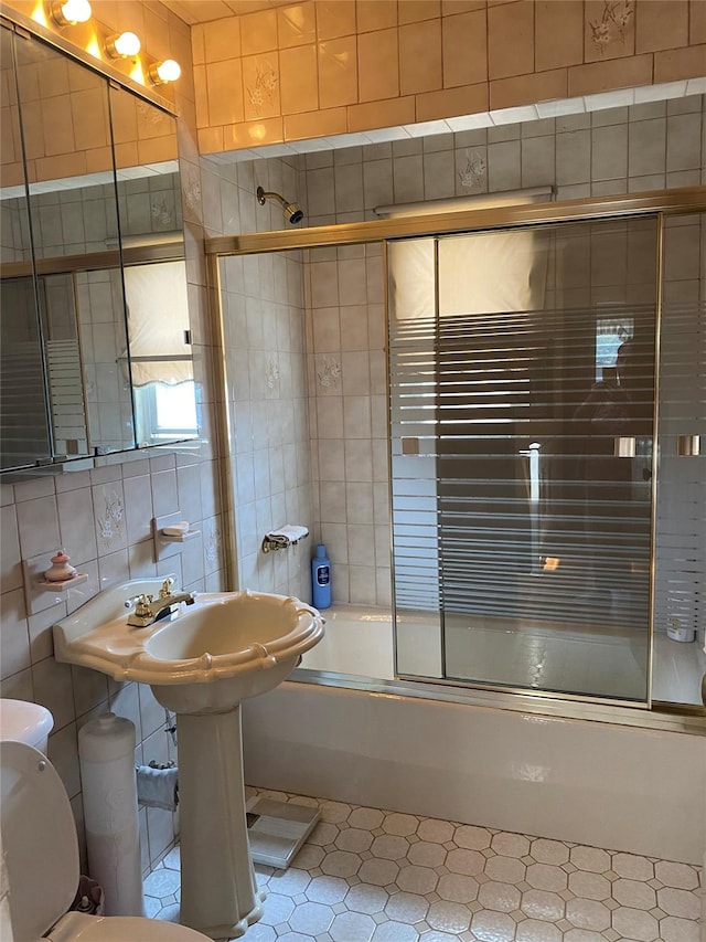 2896 Coddington Ave, Bronx, NY 10461 - full bath with shower / bath combination with glass door, tile walls, and tile patterned floors