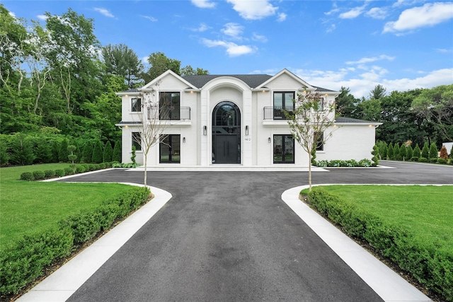 2 Maple Way, Woodbury, NY 11797 - view of front of house featuring a balcony, french doors, and a front lawn