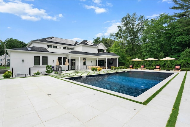 2 Maple Way, Woodbury, NY 11797 - rear view of property featuring a patio area, an outdoor pool, and roof mounted solar panels
