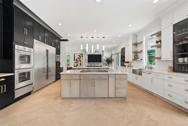 2 Maple Way, Woodbury, NY 11797 - kitchen with dark cabinetry, stainless steel appliances, a warming drawer, a kitchen island, and light countertops