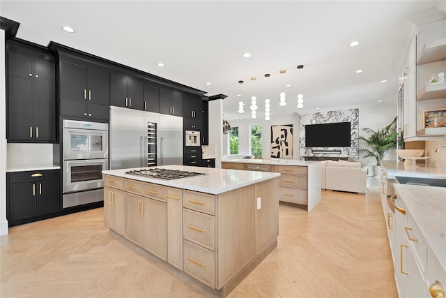 2 Maple Way, Woodbury, NY 11797 - kitchen featuring dark cabinetry, a large island, appliances with stainless steel finishes, open floor plan, and a warming drawer