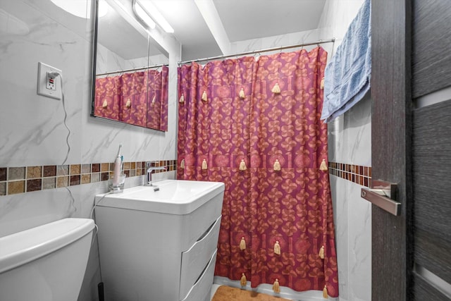 61-45 98th St Unit 11G, Rego Park, NY 11374 - bathroom with vanity, tile walls, and a shower with shower curtain