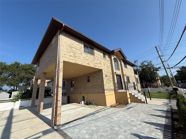1604 Robertson Pl, Bronx, NY 10465 - rear view of house featuring brick siding and a patio