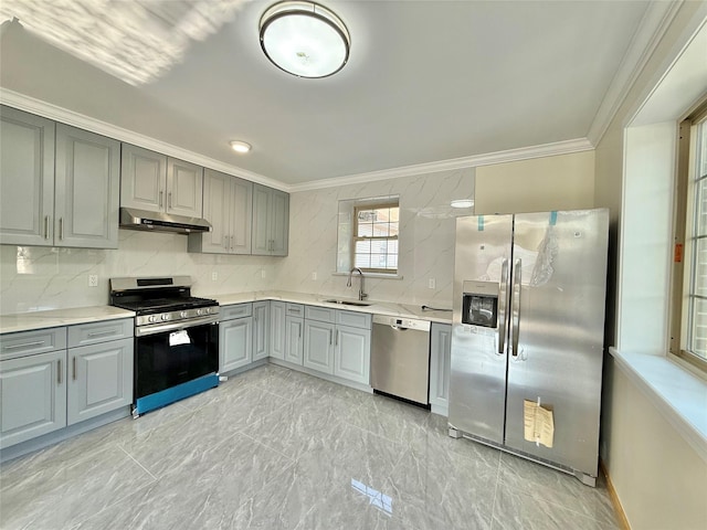1604 Robertson Pl, Bronx, NY 10465 - kitchen with stainless steel appliances, gray cabinetry, under cabinet range hood, ornamental molding, and backsplash
