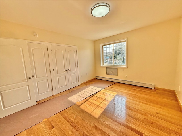 1604 Robertson Pl, Bronx, NY 10465 - unfurnished bedroom featuring a baseboard radiator, wood finished floors, and a closet