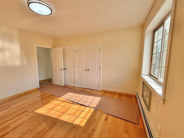 1604 Robertson Pl, Bronx, NY 10465 - unfurnished bedroom with baseboard heating and wood finished floors