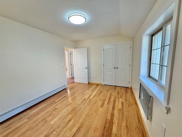 1604 Robertson Pl, Bronx, NY 10465 - unfurnished bedroom featuring a baseboard radiator, light wood-style floors, and a closet