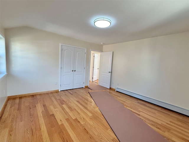1604 Robertson Pl, Bronx, NY 10465 - unfurnished bedroom with baseboard heating, light wood-style flooring, and a closet