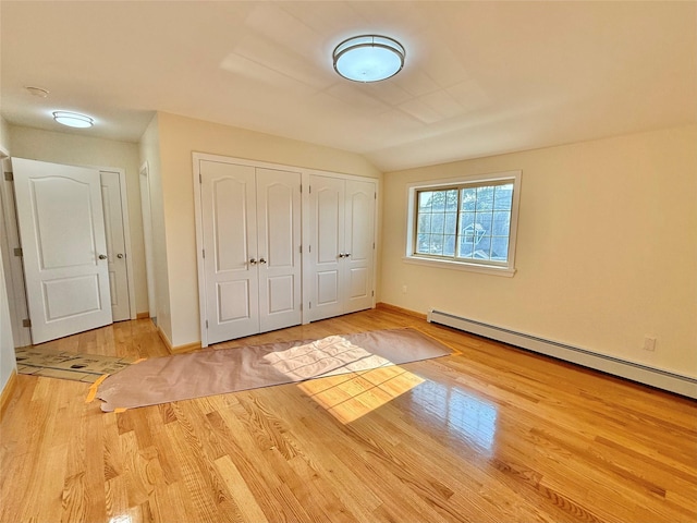 1604 Robertson Pl, Bronx, NY 10465 - unfurnished bedroom with wood finished floors, a baseboard radiator, multiple closets, and lofted ceiling