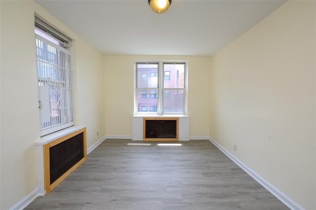 610 Waring Ave Unit 5F, Bronx, NY 10467 - unfurnished living room with light wood-style floors and heating unit