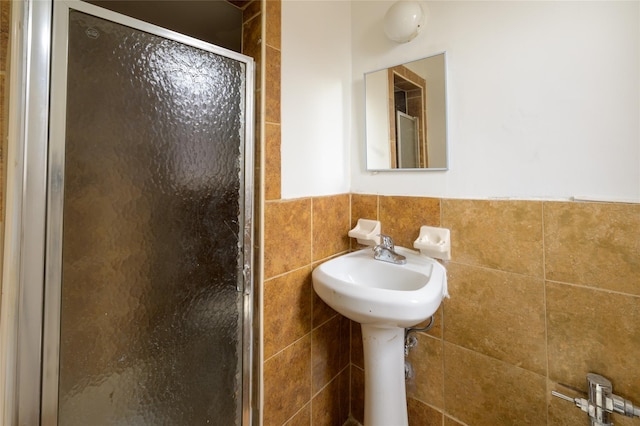 610 Waring Ave Unit 5F, Bronx, NY 10467 - bathroom featuring tile walls, a stall shower, and wainscoting