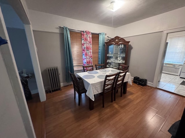 1492 E 45th St, Brooklyn, NY 11234 - dining area featuring radiator heating unit and wood finished floors
