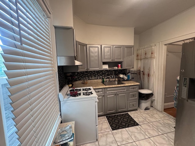 1492 E 45th St, Brooklyn, NY 11234 - kitchen featuring gray cabinetry, gas range gas stove, under cabinet range hood, and decorative backsplash