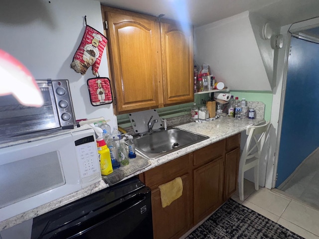 1492 E 45th St, Brooklyn, NY 11234 - kitchen featuring light tile patterned floors, white microwave, dishwasher, light countertops, and brown cabinetry