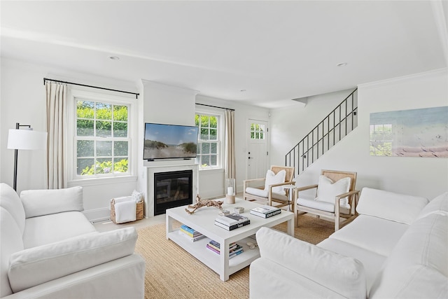 63 Armande St, Southampton, NY 11968 - living area with plenty of natural light, a glass covered fireplace, stairs, and recessed lighting