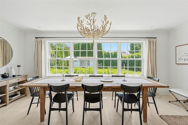 63 Armande St, Southampton, NY 11968 - dining space with ornamental molding, plenty of natural light, light wood-style flooring, and a chandelier
