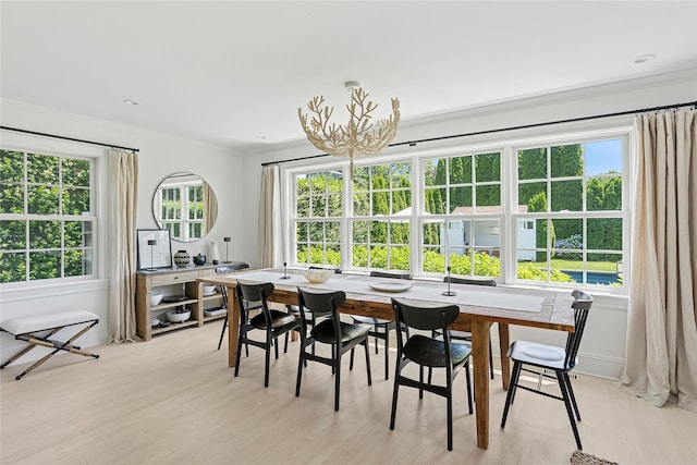 63 Armande St, Southampton, NY 11968 - dining space with light wood finished floors, ornamental molding, and a chandelier