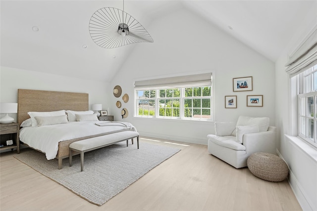 63 Armande St, Southampton, NY 11968 - bedroom featuring wood finished floors, multiple windows, and high vaulted ceiling