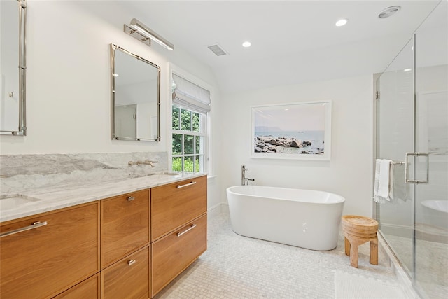 63 Armande St, Southampton, NY 11968 - bathroom with double vanity, a shower stall, a freestanding tub, tile patterned flooring, and recessed lighting