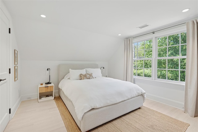 63 Armande St, Southampton, NY 11968 - bedroom with light wood-type flooring, lofted ceiling, and recessed lighting