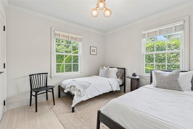 63 Armande St, Southampton, NY 11968 - bedroom featuring wood finished floors, crown molding, and a chandelier