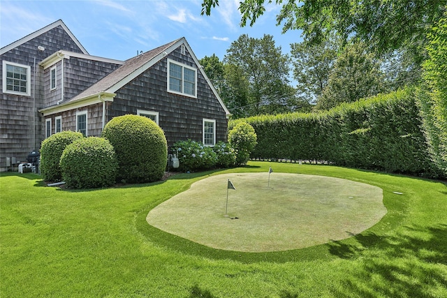 63 Armande St, Southampton, NY 11968 - view of side of property featuring an area to practice putting and a lawn