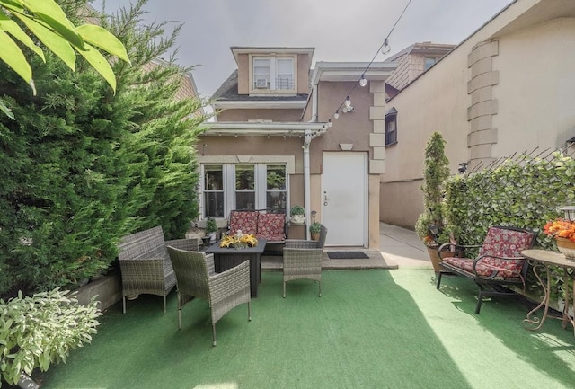 2144 73rd St, Astoria, NY 11370 - rear view of house with stucco siding and a patio area