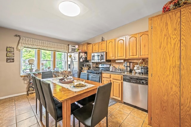 2144 73rd St, Astoria, NY 11370 - dining area featuring light tile patterned floors and baseboards