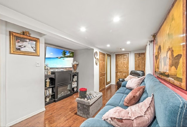 2144 73rd St, Astoria, NY 11370 - living area with wood finished floors, recessed lighting, and a glass covered fireplace