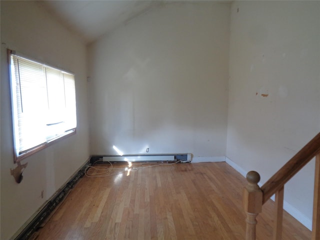 31 Marine Ave W, Lindenhurst, NY 11757 - empty room featuring a baseboard radiator, wood finished floors, and vaulted ceiling