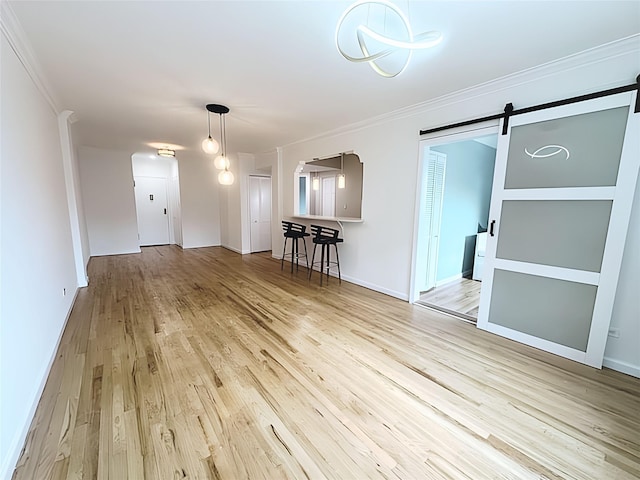 800 Grand Concourse Unit 2Js, Bronx, NY 10451 - spare room with a barn door, wood finished floors, ornamental molding, and arched walkways