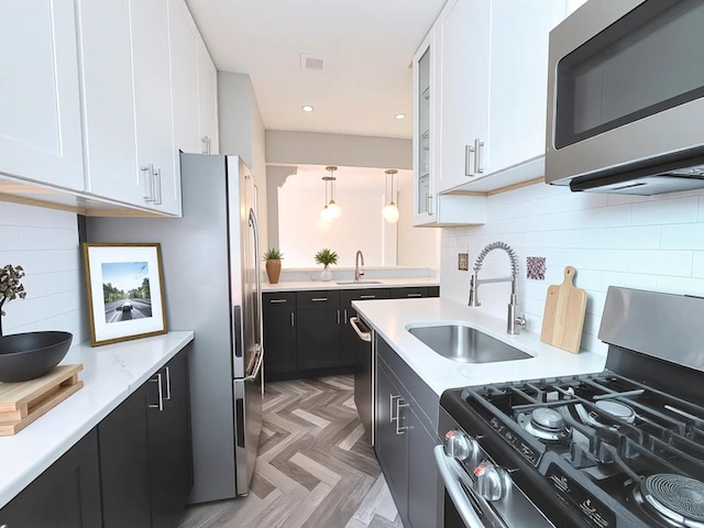 800 Grand Concourse Unit 2Js, Bronx, NY 10451 - kitchen featuring stainless steel appliances, dark cabinets, white cabinetry, decorative backsplash, and recessed lighting