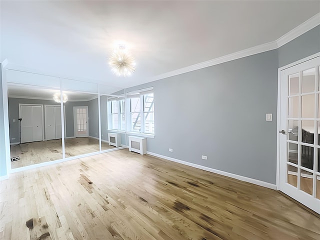 800 Grand Concourse Unit 2Js, Bronx, NY 10451 - unfurnished bedroom featuring crown molding, wood finished floors, a chandelier, and french doors