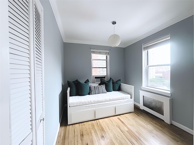 800 Grand Concourse Unit 2Js, Bronx, NY 10451 - bedroom with ornamental molding, light wood finished floors, multiple windows, and radiator