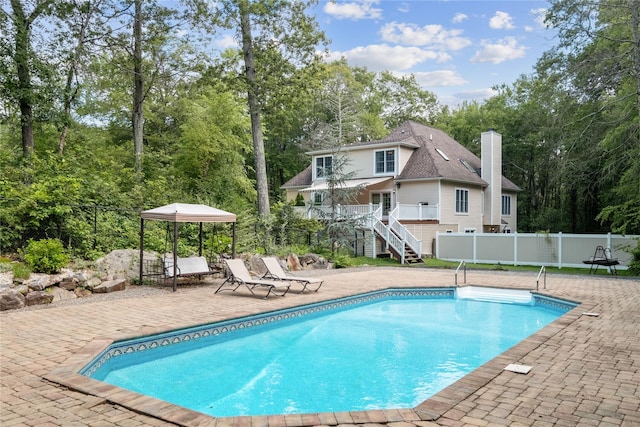 150 Hortontown Rd, Carmel, NY 10512 - view of pool with stairway, a patio area, a wooden deck, and view of wooded area