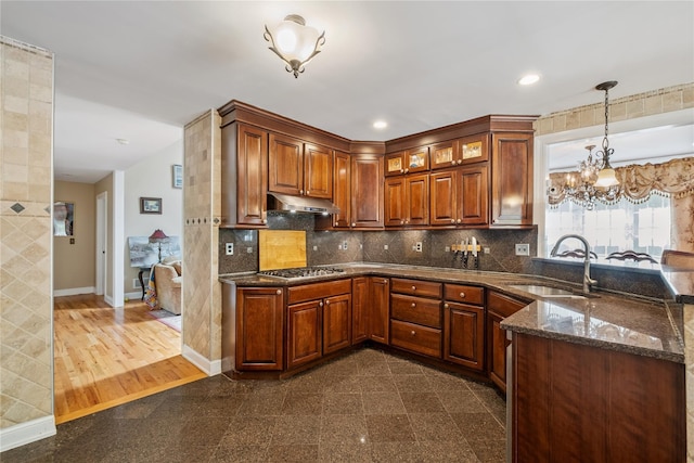150 Hortontown Rd, Carmel, NY 10512 - kitchen with under cabinet range hood, granite floors, a peninsula, stainless steel gas stovetop, and decorative light fixtures