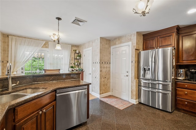 150 Hortontown Rd, Carmel, NY 10512 - kitchen with appliances with stainless steel finishes, granite tiled floors, decorative light fixtures, dark stone countertops, and brown cabinets