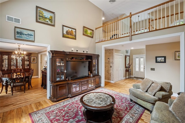 150 Hortontown Rd, Carmel, NY 10512 - living room with a towering ceiling, a chandelier, and light wood-style floors