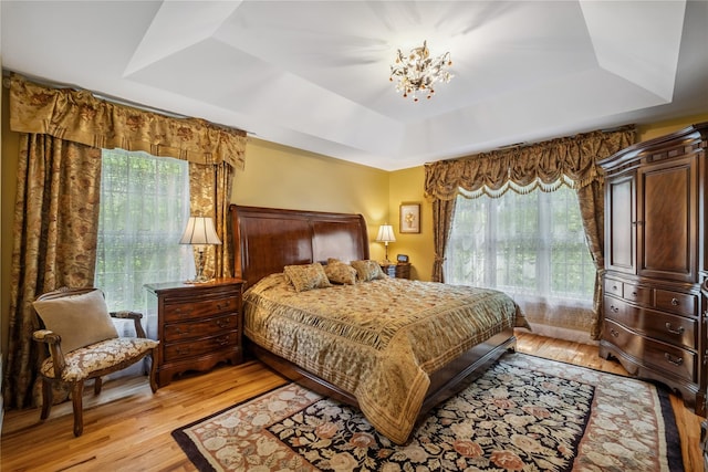 150 Hortontown Rd, Carmel, NY 10512 - bedroom featuring a raised ceiling, light wood finished floors, and a chandelier