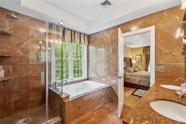 150 Hortontown Rd, Carmel, NY 10512 - bathroom featuring tile walls, connected bathroom, a shower stall, a bath, and double vanity