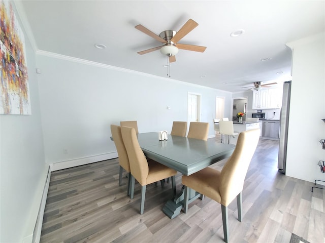 1336 Coates Ave, Holbrook, NY 11741 - dining area featuring ceiling fan, light wood finished floors, a baseboard heating unit, crown molding, and recessed lighting