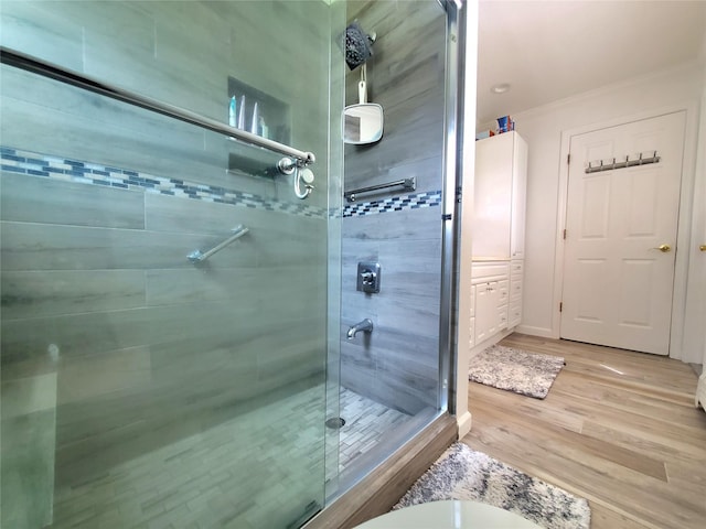 1336 Coates Ave, Holbrook, NY 11741 - full bathroom with a stall shower, wood finished floors, and crown molding