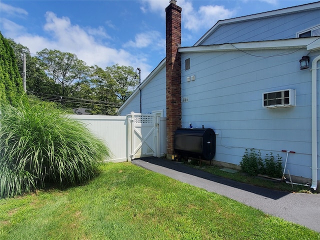 1336 Coates Ave, Holbrook, NY 11741 - view of side of home featuring a gate, a chimney, and heating fuel